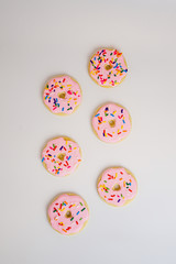 Pink sugar cookies decorated like donuts