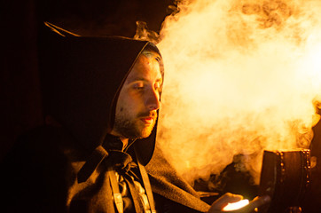 Portrait of a courageous warrior wanderer in a black cloak. Historical fantasy. Halloween.