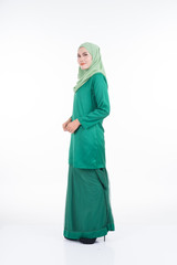 Fototapeta premium Beautiful female model in modern kurung and hijab, a modern lifestyle apparel for Muslim women isolated on white background. Beauty and hijab fashion concept. Full length portrait