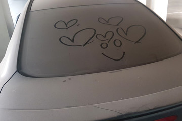 write heart  painting on very dirty car