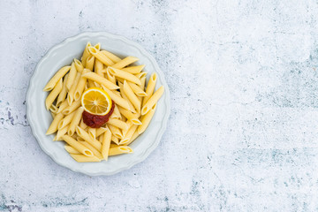 Cooked prepared Italian macaroni pasta tubes shaped on plate. Vegan vegetarian diet food
