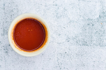 Homemade tomato chilly red paste sauce in saucepan. Vegan vegetarian diet food