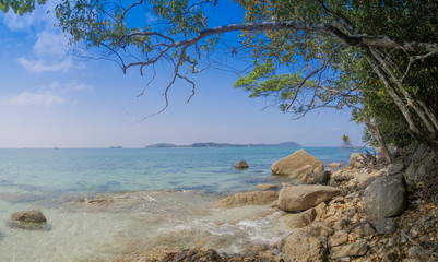 view seaside of many arch rocks floating in blue-green sea around with green trees and blue sky background, Adang island, Tarutao Marine National Park, Satun, southern of Thailand.