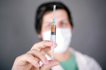 coronavirus vaccine, doctor  holds a syringe with vaccination. medicinal scientists have found a...