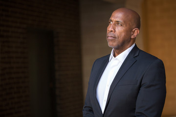 Mature African American casually dressed businessman smiling.