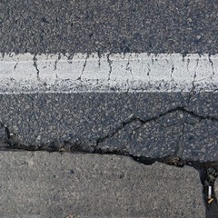 Obraz premium Cracked Asphalt with White Stripe Texture