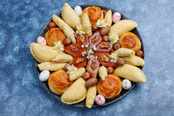 Traditional Azerbaijan holiday Novruz cookies baklavas and shakarburas on black tray plate on dark background