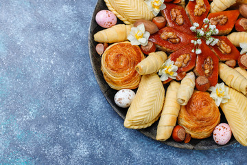 Traditional Azerbaijan holiday Novruz cookies baklavas and shakarburas on black tray plate on dark background