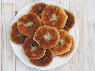 Belyasha homemade baking with meat on a white rustic wooden table.