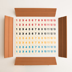 Grid of numbers in colors from 1 to 13 made out of rummy pieces