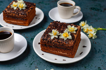 Tasty homemade chocolate truffle cakes with coffee on dark background