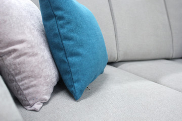 Decorative pillows on a modern sofa. The concept of home comfort, Scandinavian style.