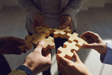 Crop coworkers idea stacking wooden puzzles together