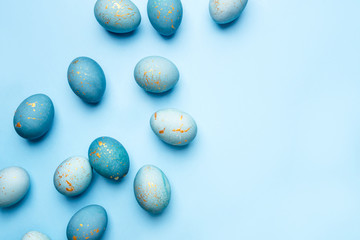 Easter frame of eggs painted in blue color. Flat lay, top view. Copy space for text.
