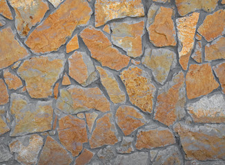 Old castle wall, antique natural stone wall. Pattern gray color, decorative uneven cracked real stone wall surface with cement.