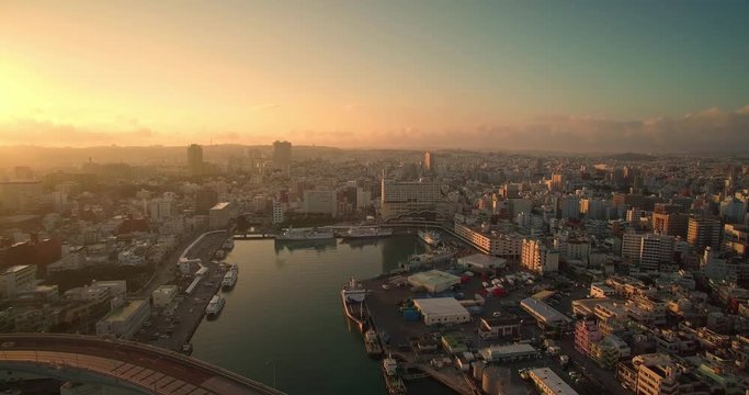 Aerial view of Naha city Okinawa Japan at sunrise with ocean views and Tomari port drone shot