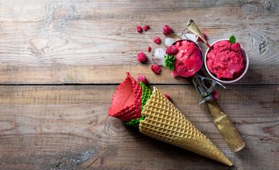 Raspberry sorbet, ice cream on a wooden background. Vintage ice cream spoon. Copy space.