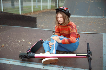 Teenage girl fallen off her kick scooter outdoors © Pixel-Shot