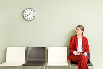 Young woman waiting for job interview indoors