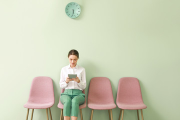 Young woman waiting for job interview indoors
