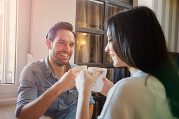 Beauty caucasian couple having nice moments at home enjoying in hugs, coffee and time together