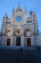 Exterior facade of the cathedral of Siena with the light of sunset.