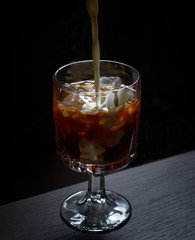 Alcoholic cocktail on the bar. The process of making an alcoholic cocktail.