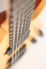 Fototapeta premium Classic shape wooden electric guitar with rosewood neck closeup. Six stringed learning lesson musician school education art leisure electrical vintage stage wood guitar concept