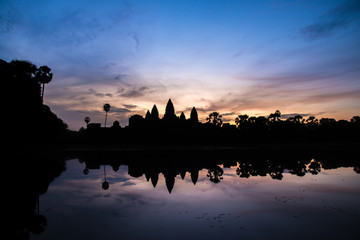 Fototapeta na wymiar Reflection of an Angkor Wat in silhouette look in Siem Reap, Cambodia.