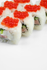 sushi roll with tuna, scrambled eggs, cream cheese and red caviar. white background