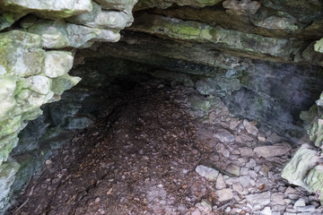 entrance to a limestone cave in the czech karst
