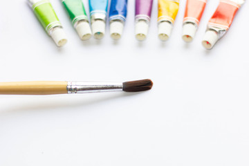 Watercolor and brushes at white background. Flat lay, top view