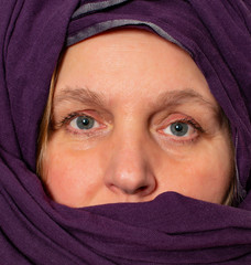 Model with beautiful eyes has a turban around her face