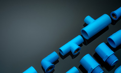 Set of blue PVC pipe fittings isolated on dark background. Blue plastic water pipe. PVC accessories...