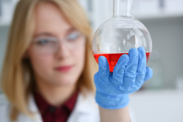 Technician hold in arms in protective gloves sample bottle with poison fluid portrait. Medical...