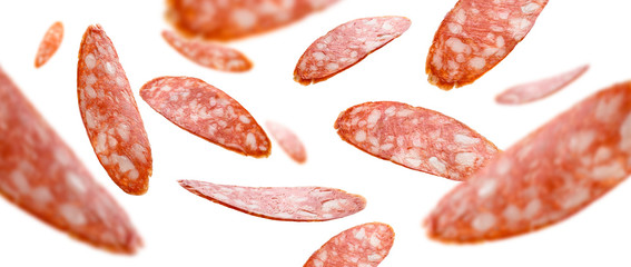Sausage slices levitate on a white background