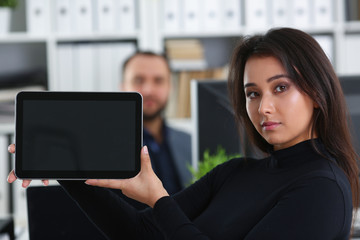 young pretty brunette woman in office work with her boss hold tablet in hands