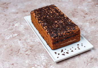 Tasty homemade chocolate truffle cake with coffee on light background
