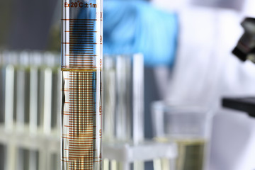 Yellow liquid spilled petrol additive innovative supply. Conveyor line production household cleaning products detergents help cleaning destruction stains pests urine poison antidote vaccine concept.