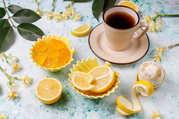 Lemon jelly candies with fresh lemons on light background,top view
