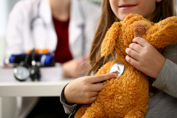 Female hand of little girl hold stethoscope listen heart bit concept closeup