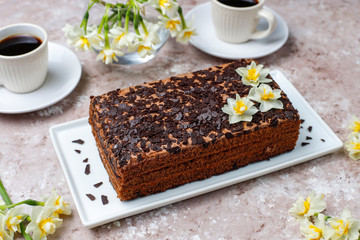 Tasty homemade chocolate truffle cake with coffee on light background