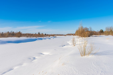 River swept by snow on a bright sunny day