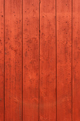 Red wooden wall of a Norwegian cabin or barn