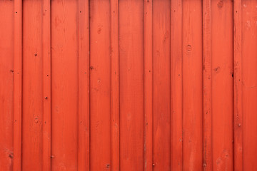 Red wooden wall of a Norwegian cabin or barn
