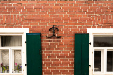 Brick wall and green shutters