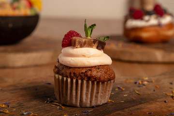 healthy carrot muffin on wooden cutting board