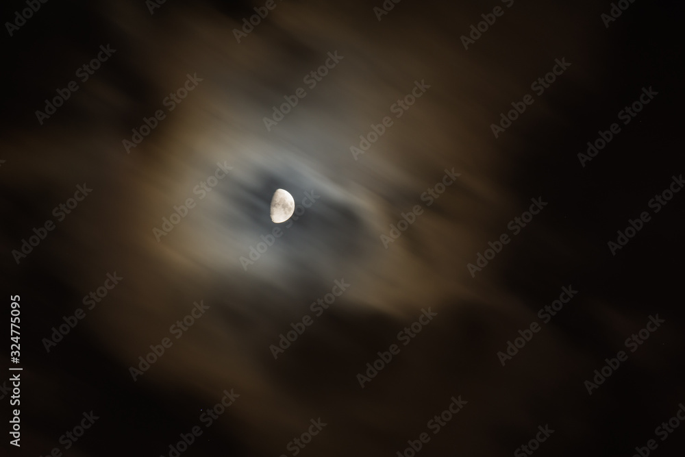 Wall mural moon on in the night sky among clouds; natural background of the night sky with the moon