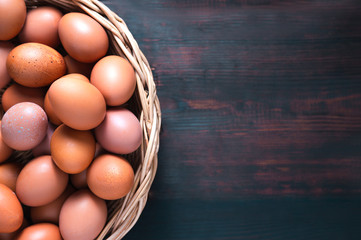 Chicken eggs lay on oak colored wooden tables copy space.
