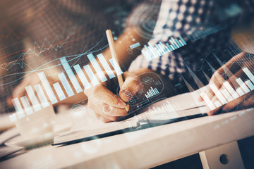 Multi exposure of two men planing investment with stock market forex chart.